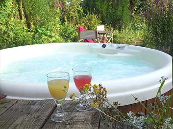 2 refreshing drinks sitting beside the hot tub